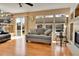 Inviting living room with hardwood floors, sliding glass doors to the back yard, and contemporary furnishings at 20948 E Hamilton Ave, Aurora, CO 80013