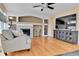Comfortable living room with hardwood floors, fireplace, TV, decorative vases, and neutral color scheme at 20948 E Hamilton Ave, Aurora, CO 80013