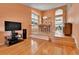 Open-concept living room with hardwood floors and natural light from large windows at 20948 E Hamilton Ave, Aurora, CO 80013