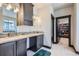Bathroom with double vanity, granite countertops, and a walk-in closet at 23774 E 36Th Pl, Aurora, CO 80019