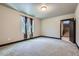Bedroom featuring gray carpet flooring, a window with curtains, and stairs at 23774 E 36Th Pl, Aurora, CO 80019