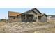 Rear exterior view of the house showcasing a covered patio and spacious backyard at 23774 E 36Th Pl, Aurora, CO 80019