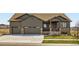Charming single-Gathering home featuring a two-car garage, covered porch, and stone accents at 23774 E 36Th Pl, Aurora, CO 80019