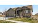 Charming single-Gathering home featuring a two-car garage, covered porch, and stone accents at 23774 E 36Th Pl, Aurora, CO 80019