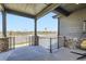 Inviting covered porch with stone pillars, metal railings, and comfortable seating at 23774 E 36Th Pl, Aurora, CO 80019