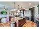 Open-concept kitchen featuring a large island, hardwood floors, and stainless steel appliances at 23774 E 36Th Pl, Aurora, CO 80019