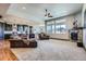 Spacious living room with plush seating, fireplace, and an open layout to the kitchen at 23774 E 36Th Pl, Aurora, CO 80019