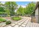 Backyard with paved walkway, lush landscaping, and a tranquil garden setting at 3519 S Holly St, Denver, CO 80237