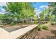 Picturesque backyard featuring stone accents, mature trees, and lush greenery at 3519 S Holly St, Denver, CO 80237
