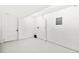Unfinished basement with clean white walls, utility hookups, and an exterior door for easy access at 3519 S Holly St, Denver, CO 80237
