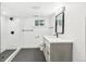 Contemporary bathroom featuring gray vanity, sleek fixtures, walk-in shower, and modern lighting at 3519 S Holly St, Denver, CO 80237