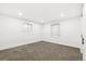Finished basement bedroom with neutral carpet, white walls, recessed lights, and bright egress windows at 3519 S Holly St, Denver, CO 80237