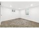 Finished basement bedroom with neutral carpet, white walls, recessed lights, and a bright egress window at 3519 S Holly St, Denver, CO 80237