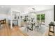 Bright dining room with hardwood floors, modern chandelier, and open floor plan at 3519 S Holly St, Denver, CO 80237