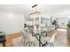 Bright dining room with hardwood floors, modern chandelier, and open floor plan at 3519 S Holly St, Denver, CO 80237