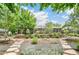 Charming single-story home with manicured landscaping, a stone retaining wall, and a welcoming facade at 3519 S Holly St, Denver, CO 80237