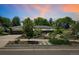 Charming home with lush front yard landscaping, a lovely walkway, and beautiful trees at 3519 S Holly St, Denver, CO 80237