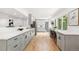 Spacious kitchen featuring long countertops, bright cabinets, hardwood floors, and modern lighting at 3519 S Holly St, Denver, CO 80237