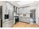 Well-lit kitchen featuring stainless steel appliances, sleek gray cabinets, and a bright skylight at 3519 S Holly St, Denver, CO 80237