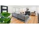 Cozy living room with a modern sofa, fireplace, and a view of the front yard at 3519 S Holly St, Denver, CO 80237