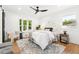 Bright bedroom featuring a bay window, modern ceiling fan and contemporary decor at 3519 S Holly St, Denver, CO 80237