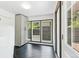 Sunlit mudroom features sleek storage cabinets, black hexagonal tile floors, and an exterior door at 3519 S Holly St, Denver, CO 80237