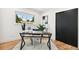 Bright home office featuring a large window, modern desk, and stylish decor at 3519 S Holly St, Denver, CO 80237