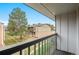 Balcony overlooking a well-maintained lawn, mature tree and exterior of adjacent building at 544 Vance St, Lakewood, CO 80226