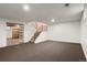 Finished basement featuring neutral carpet, freshly painted walls, stairs, and a storage room at 544 Vance St, Lakewood, CO 80226