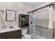 Stylish bathroom featuring a vanity, modern shower, and dark wood accents at 544 Vance St, Lakewood, CO 80226
