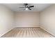 Spacious, carpeted empty bedroom featuring a ceiling fan and two windows at 544 Vance St, Lakewood, CO 80226