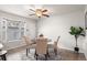 Cozy dining area with a round table, three chairs, and natural lighting at 544 Vance St, Lakewood, CO 80226