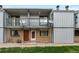 Exterior elevation of home featuring brick facade, balconies, and well maintained lawn at 544 Vance St, Lakewood, CO 80226