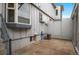 Exterior view featuring neutral siding, an air conditioning unit, and small windows at 544 Vance St, Lakewood, CO 80226