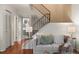 Bright living room featuring hardwood floors, comfortable seating and staircase access at 544 Vance St, Lakewood, CO 80226