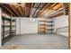 Unfinished storage room with wood shelves and exposed piping on the ceiling providing ample storage space at 544 Vance St, Lakewood, CO 80226