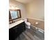 Bathroom with a black vanity, toilet, updated lighting, and a shower that has a clear glass door at 3415 S Ammons St # 24-2, Lakewood, CO 80227