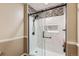 Modern bathroom featuring glass shower doors, stylish tile accents, and a built-in niche for toiletries at 3415 S Ammons St # 24-2, Lakewood, CO 80227