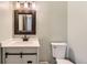 A bathroom features a modern vanity with matte fixtures, and updated lighting and mirror at 3415 S Ammons St # 24-2, Lakewood, CO 80227