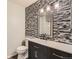 Bathroom featuring a vanity with drawers and decorative hardware, a modern light fixture and a decorative mirror at 3415 S Ammons St # 24-2, Lakewood, CO 80227