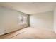 A bedroom featuring carpet flooring, and neutral walls, and a window overlooking nature at 3415 S Ammons St # 24-2, Lakewood, CO 80227