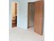Bedroom with an open doorway to a bathroom and closet, offering comfort and functionality at 3415 S Ammons St # 24-2, Lakewood, CO 80227