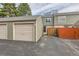 Exterior view of the condo detached garage near a partially fenced patio area in an outdoor setting at 3415 S Ammons St # 24-2, Lakewood, CO 80227