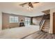 Living room with a fireplace, wood accent wall, carpet flooring, and staircase at 3415 S Ammons St # 24-2, Lakewood, CO 80227
