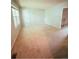 Spacious, carpeted living room with plenty of natural light from a large window at 3415 S Ammons St # 24-2, Lakewood, CO 80227
