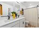 Bathroom featuring double sinks, modern fixtures, a striped shower curtain and sleek finishes at 673 N Tempe St, Aurora, CO 80018
