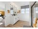 Bright bathroom with dual sinks, modern lighting, wood-look floors, and contemporary finishes at 673 N Tempe St, Aurora, CO 80018