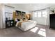Bright bedroom featuring an accent wall, a plush bed with decorative pillows, and lots of natural light at 673 N Tempe St, Aurora, CO 80018