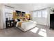 Bright bedroom featuring an accent wall, a plush bed with decorative pillows, and lots of natural light at 673 N Tempe St, Aurora, CO 80018