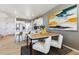 Well-lit dining area adjacent to a modern kitchen, offering a comfortable and functional space for dining and socializing at 673 N Tempe St, Aurora, CO 80018